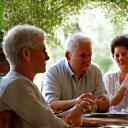 A diverse group of adults aged 40-60 engaging in a friendly group discussion, symbolizing age-specific support.